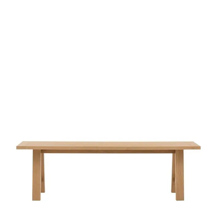 Gallery Direct Eton Trestle Bench features a grooved and planked oak wood seat and a trestle style frame