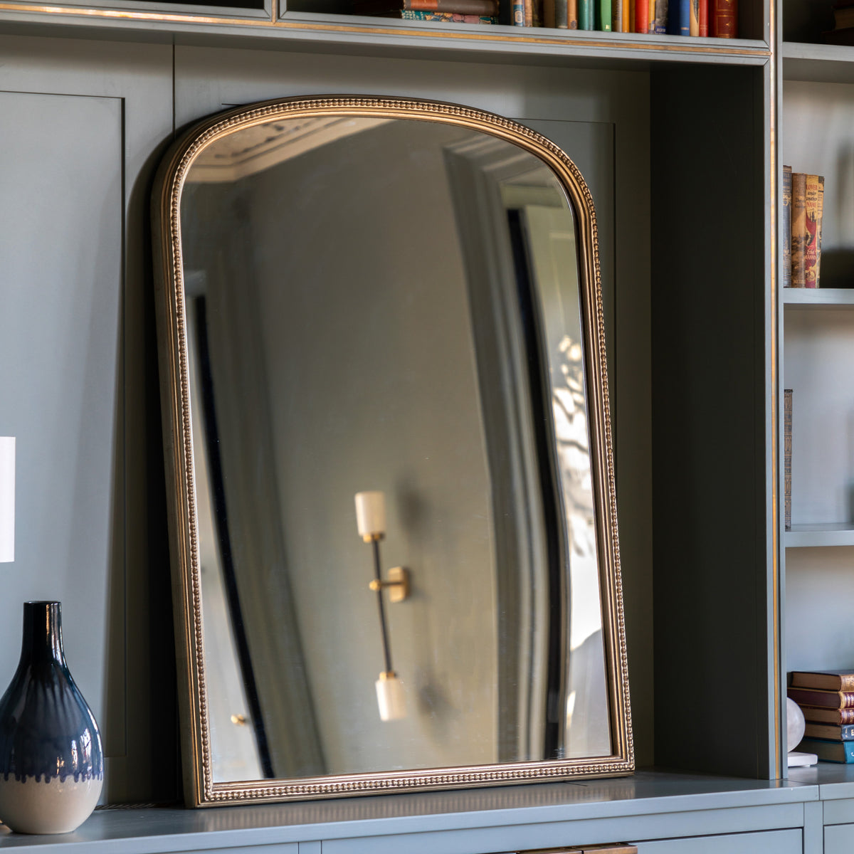 Gallery Direct Florentine Overmantle Mirror Champagne displayed in a styled interior