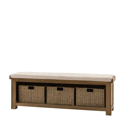 Gallery Direct Hardwick Hall Bench is crafted from solid oak wood and veneers, with 3 natural wicker baskets and a generously padded seat cushion