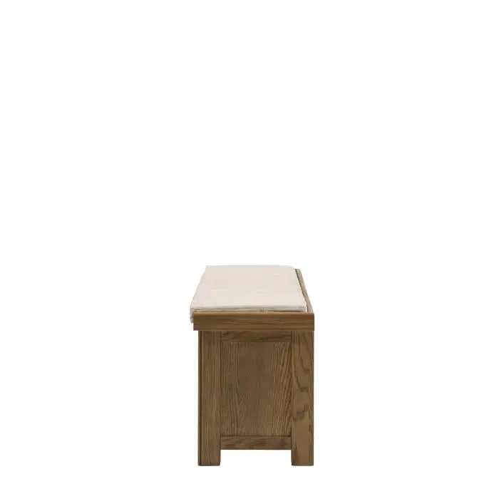Gallery Direct Hardwick Hall Bench features a natural coloured cushioned seat and a warm oak wood and veneer frame
