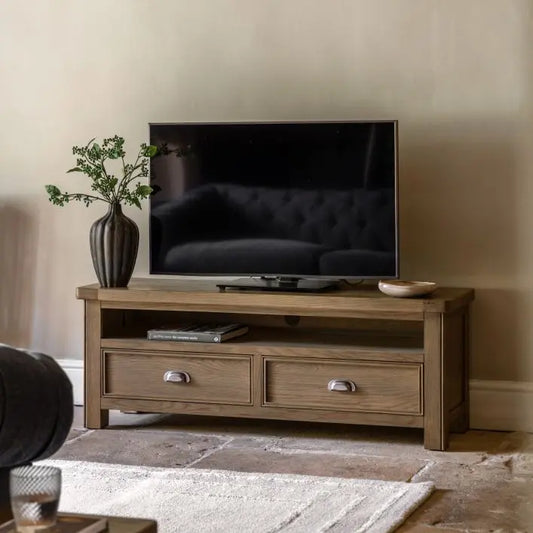 Gallery Direct Hardwick 2 Drawer Media Cabinet features a media shelf with access for cables at the rear. Crafted from oak solids and veneers with a warm natural wood finish 