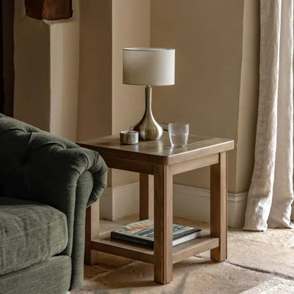 Gallery Direct Hardwick Side Table features a square table top and lower shelf, crafted from solid oak and veneers in a warm natural finish. Works well in both contemporary and traditional interiors
