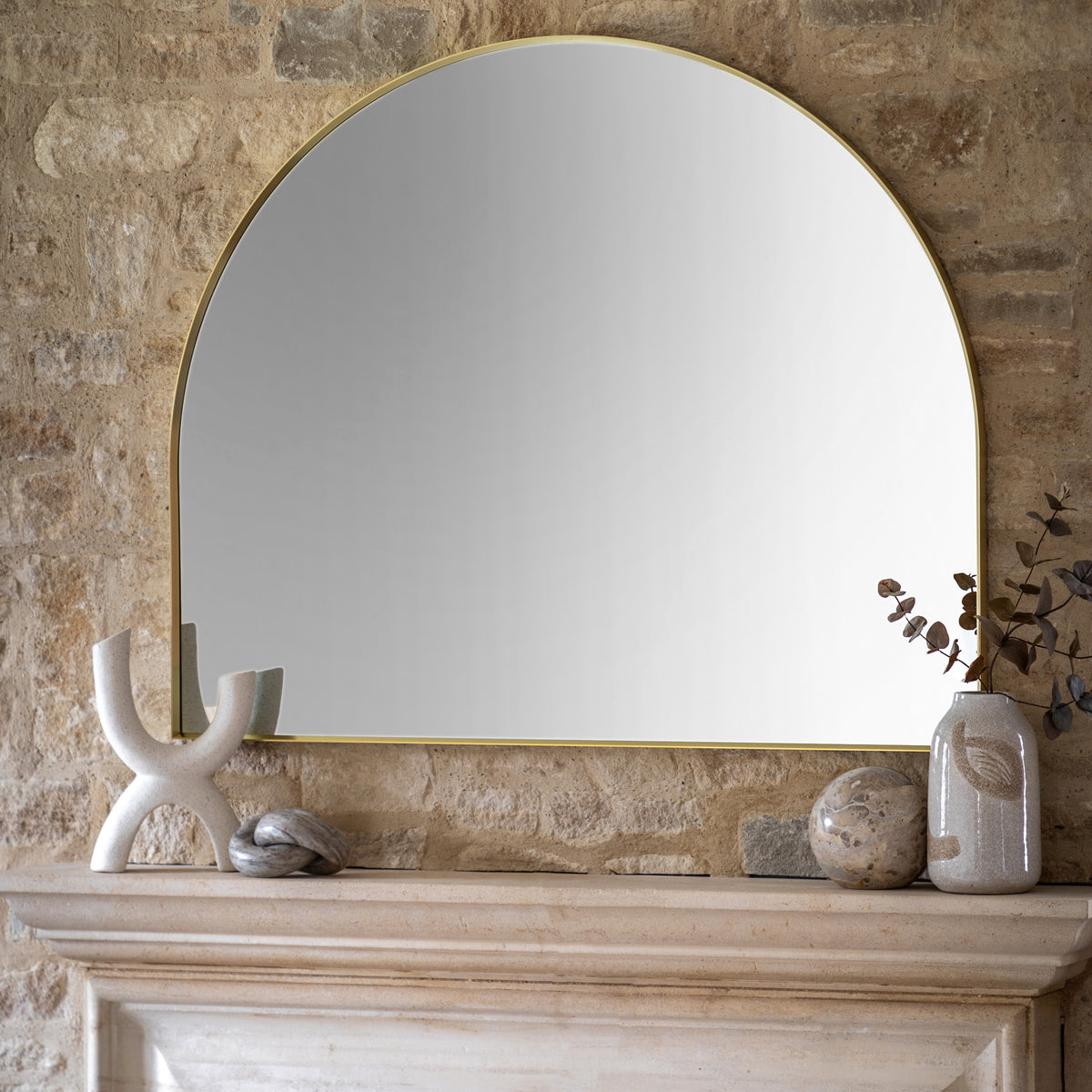 Gallery Direct Holworth Overmantle Mirror Gold displayed in a styled interior