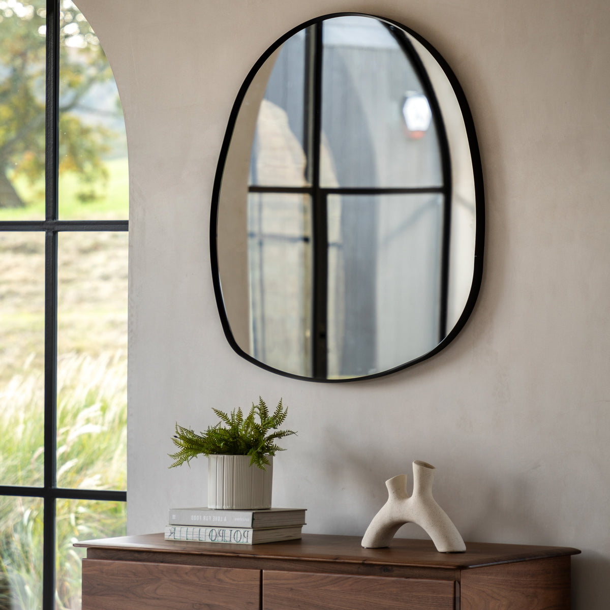 Gallery Direct Holworth Pebble Mirror Black displayed in a styled interior