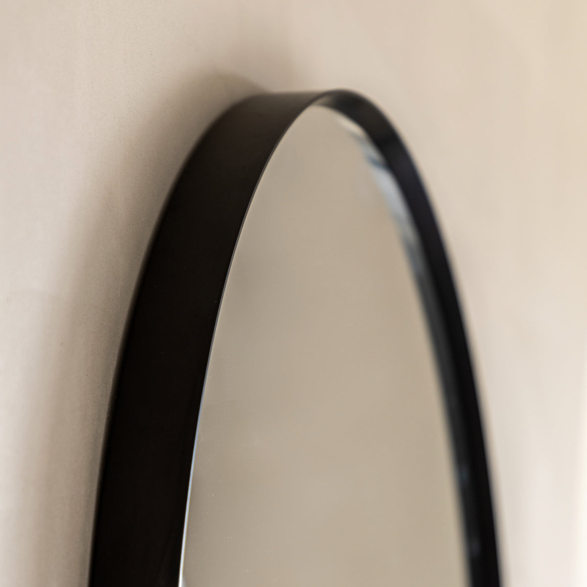 Gallery Direct Holworth Pebble Mirror Black, close-up of the mirror and frame details