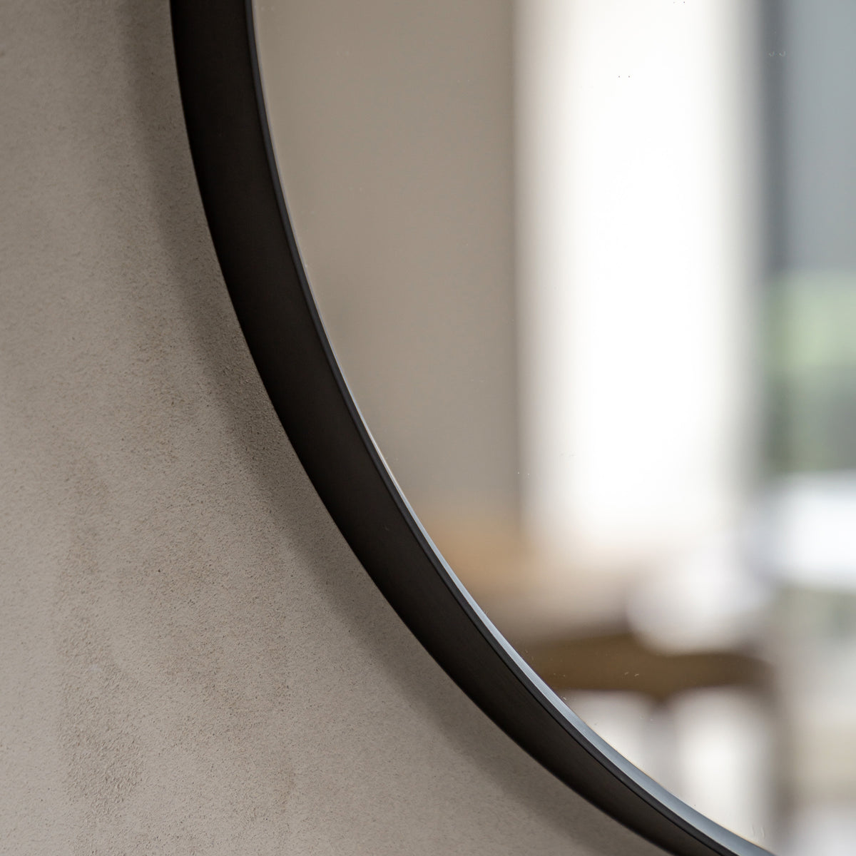 Gallery Direct Holworth Pebble Mirror Black, close-up of the mirror and frame details