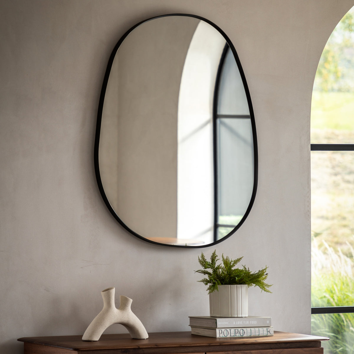 Gallery Direct Holworth Pebble Mirror Black displayed in a styled interior