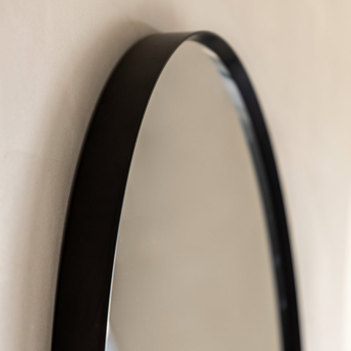 Gallery Direct Holworth Pebble Mirror Black, close-up of the mirror and frame details