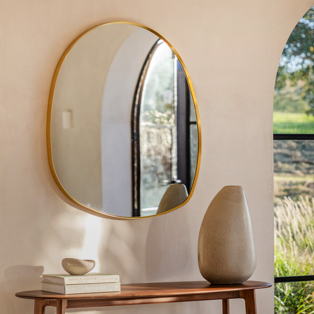 Gallery Direct Holworth Pebble Mirror Gold displayed in a styled interior