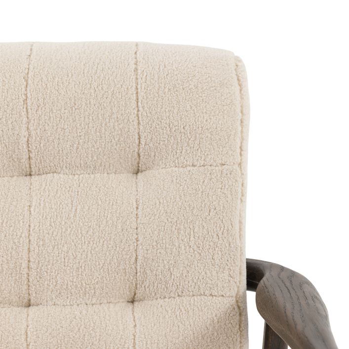 Gallery Direct Humber Armchair is upholstered in a Cream coloured Faux Sheepskin material with a dark ash wood frame