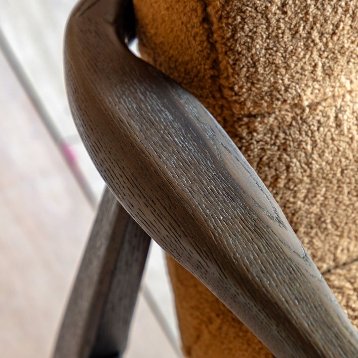 Gallery Direct Humber Armchair has a dark ash wood frame and is upholstered in Ochre coloured Faux Sheepskin fabric