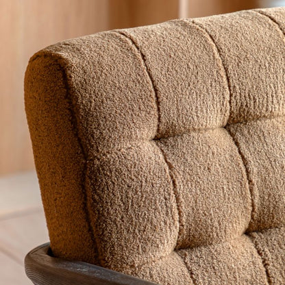 Gallery Direct Humber Armchair is upholstered in an Ochre Coloured Faux Sheepskin material within a dark wooden frame