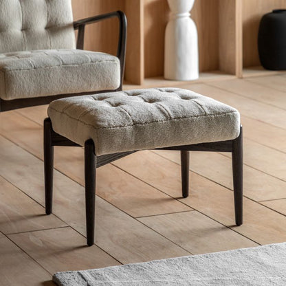 Gallery Direct Humber Faux Sheepskin Footstool in Cream coloured fabric with dark wooden base and legs