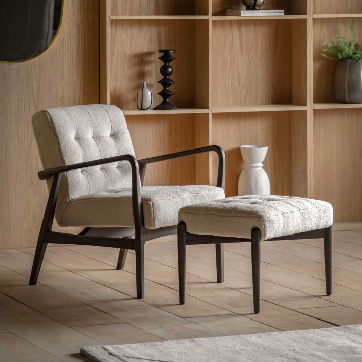 Gallery Direct Humber Faux Sheepskin Footstool in Cream Fabric, with dark wooden legs. A matching armchair is also available