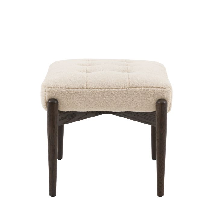 Gallery Direct Humber Footstool in a luxurious Cream Faux Sheepskin fabric, with dark wooden legs