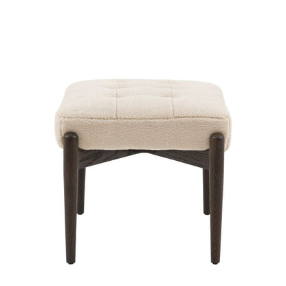 Gallery Direct Humber Footstool in a luxurious Cream Faux Sheepskin fabric, with dark wooden legs