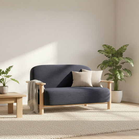 The Gallery Direct Husby 2 Seater Sofa features a modern and minimalistic light wooden frame and a generously cushioned seat upholstered in Willow Pacific blue linen fabric