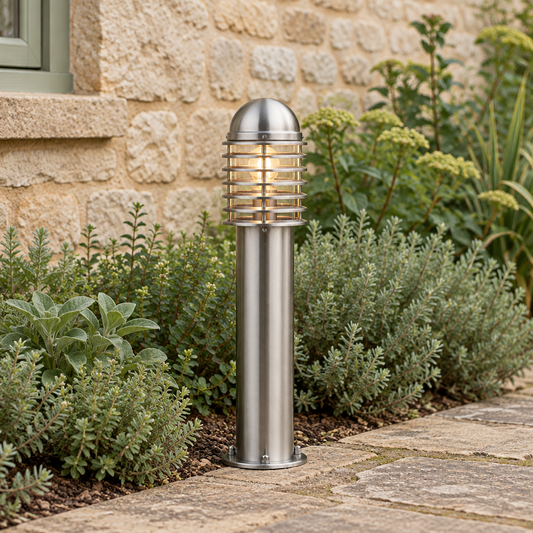 Gallery Direct Louvre Floor Lamp beside a stone garden path with the complete short bollard visible