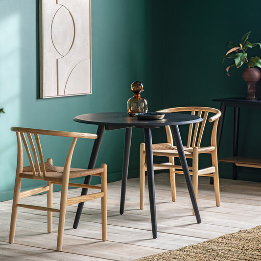 Gallery Direct Maddox Round Dining Table Black styled with chairs in a dining room