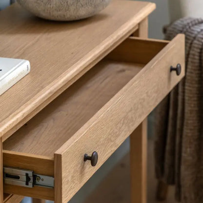 Gallery Direct Malvern Console Table features 1 wide drawer with metal handles and is constructed from premium oak solids and veneers with wood-grain patterns