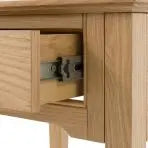 Gallery Direct Malvern 1 Drawer Side Table crafted from solid oak woods and veneers with wood grain patterns and a metal drawer knob