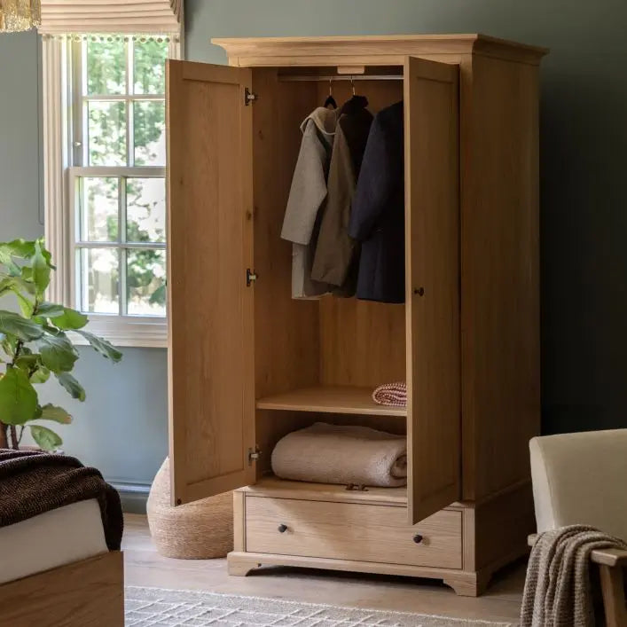 Gallery Direct Malvern Wardrobe features Double Doors with internal hanging rail and shelf, and 1 Lower Drawer, constructed from solid oak wood and veneers with round metal handles