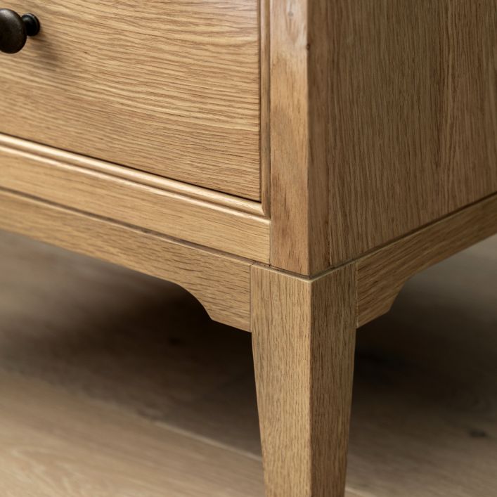 Gallery Direct Malvern 2 Drawer Bedside table is made using solid oak woods and veneers with natural wood grain patterns, with metal handles and slim tapered legs