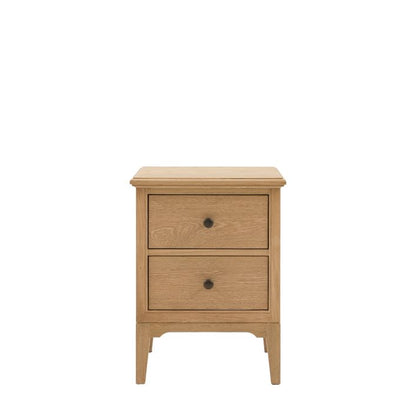 Gallery Direct Malvern Bedside Cabinet is crafted from warm oak woods and veneers, with 2 drawers, metal handles and slim tapered legs