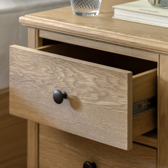 Gallery Direct Malvern 2 Drawer Bedside Cabinet made from solid oak woods and veneers with natural wood-grain patterns, and dark metal handles