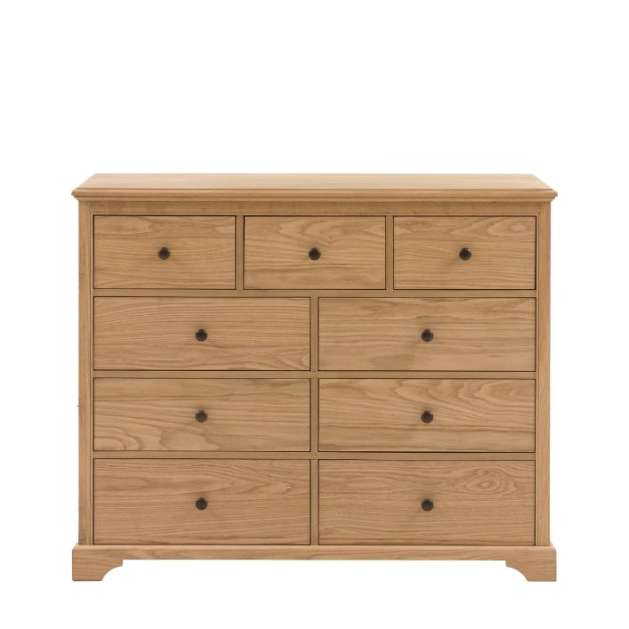 Gallery Direct Malvern 9 Drawer Chest is constructed using premium oak solids and veneers with wood-grain pattern and complemented by dark metal knobs