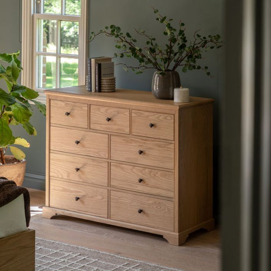 Gallery Direct Malvern Large Chest features a total of 9 drawers, 3 small top drawers and 6 larger lower ones, with dark metal handles that complement the oak wood-grained finish
