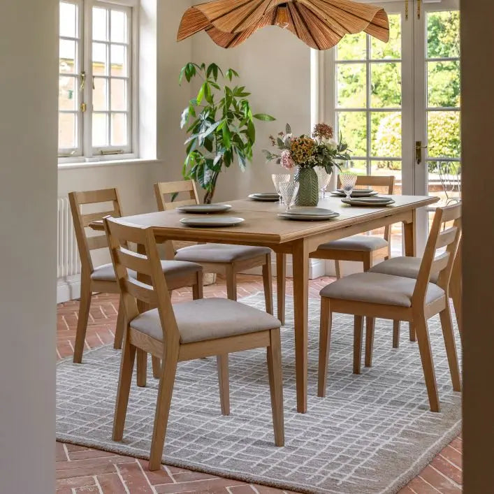Gallery Direct Malvern Rectangular Dining Table with natural wood finish can be extended to seat up to 6 people