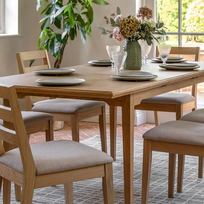 Gallery Direct Malvern Extending Dining Table can seat up to 6 people and is crafted from solid oak woods and veneers with a natural wood-grain finish