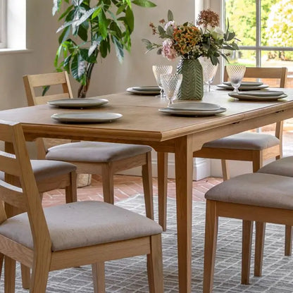 Gallery Direct Malvern Extending Dining Table can seat up to 6 people and is crafted from solid oak woods and veneers with a natural wood-grain finish
