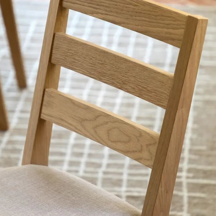 Gallery Direct Malvern Pair of Dining Chairs with a slatted back, wood and oak veneer frame and a padded neutral colour seat fabric