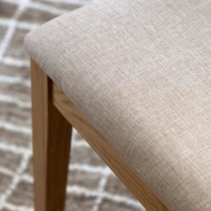 Gallery Direct Malvern Pair of Upholstered Dining Chairs, with a natural wood frame and neutral tone padded seat