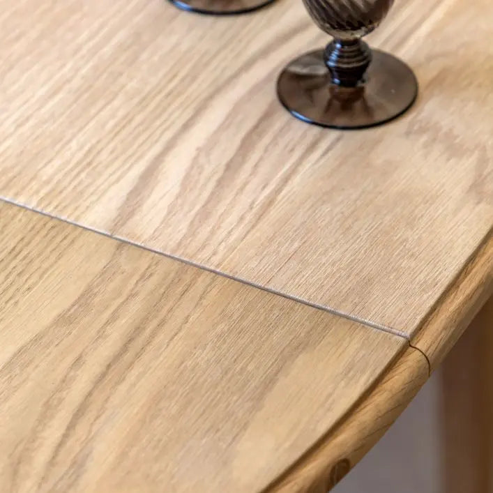 Gallery Direct Malvern Round Extending Dining Table can seat between 4-6 people when extended, crafted from oak solids and veneers with wood-grain pattern