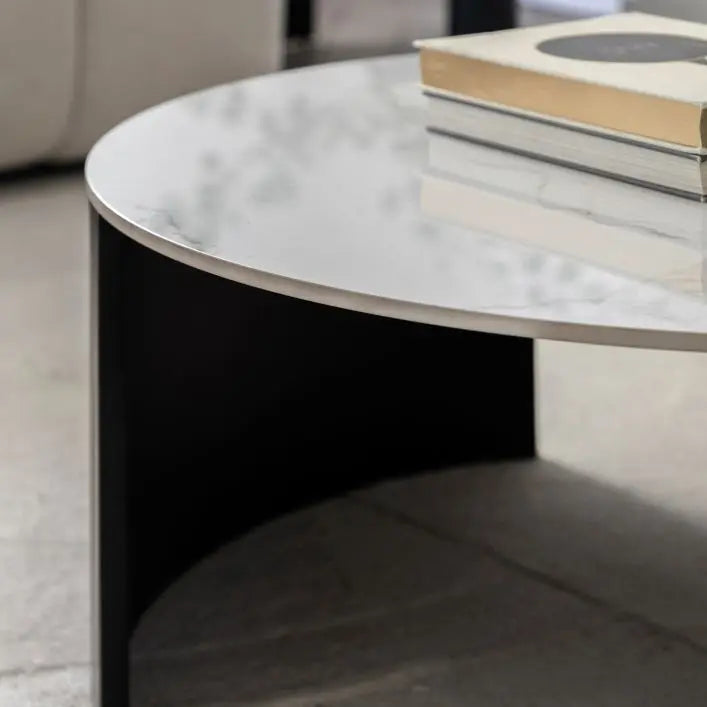 Gallery Direct Marzio Round Coffee Table made from Carrara marble-style stone and paired with gently curved, matt black metal legs