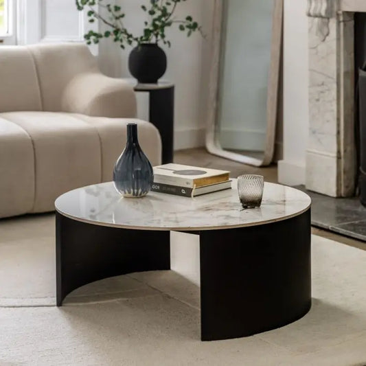 The Gallery Direct Marzio Round Coffee Table with striking Carrara marble-style stone table top and curved, black metal legs for a practical, durable and contemporary design