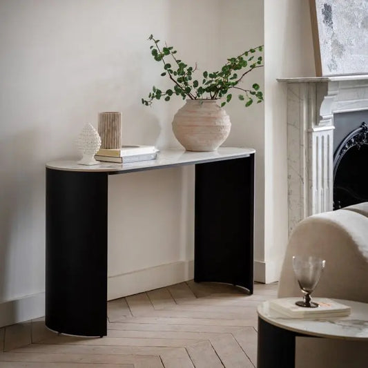 The Gallery Direct Marzio Carrara marble Console Table features a curved design and contrasting matt black metal legs, for a modern, contemporary design