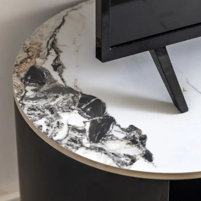 Gallery Direct Marzio Media Unit features a Carrara marble stone top with veining and matt black curved frame 