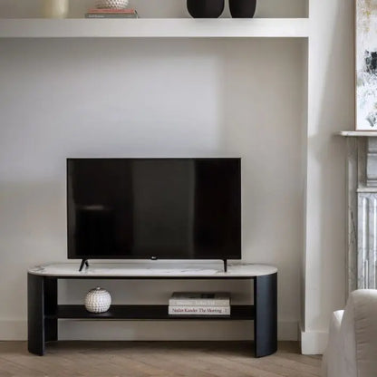 Gallery Direct Marzio Media Unit features a striking Carrara marble stone table top, matt black curved metal legs and a middle shelf for storage