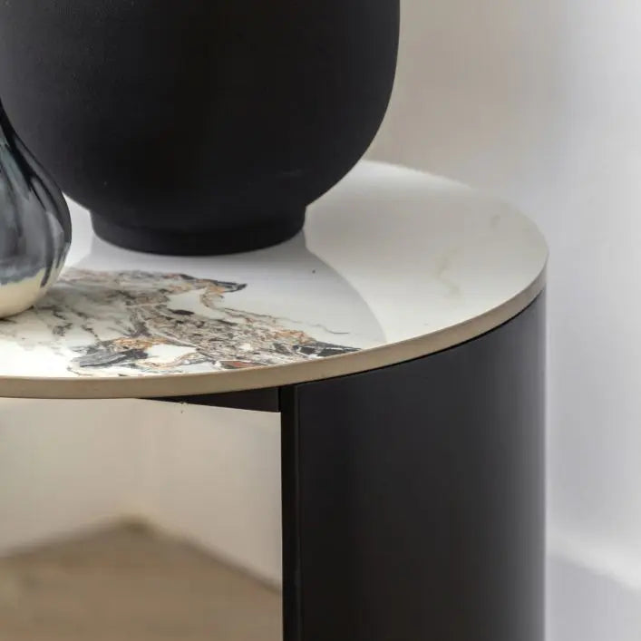 Gallery Direct Marzio Side Table features a round Carrara stone table top with natural veining, and black curved metal legs