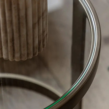 The Gallery Direct Monti Side Table is a round glass top table with a bronze metal frame