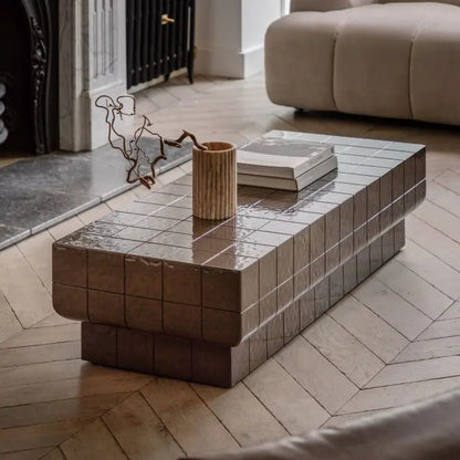 The Gallery Direct Novara Rectangular Coffee Table is an Italian Retro inspired piece crafted from reinforced glass concrete with a faux tile pattern and charcoal brown glaze