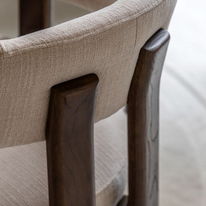 Gallery Direct Onda Dining Chair features a padded seat and backrest in a Natural coloured linen with dark wood frame