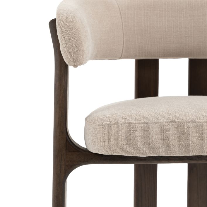 The Gallery Direct Onda Dining Chair has a dark wooden frame and legs with upholstered padded back and seat cushions in a Natural coloured fabric