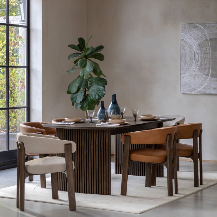 The Gallery Direct Onda Dining Chair is available in a Natural linen or Brown leather, both are framed in a rich charcoal brown wood with a modern curved design