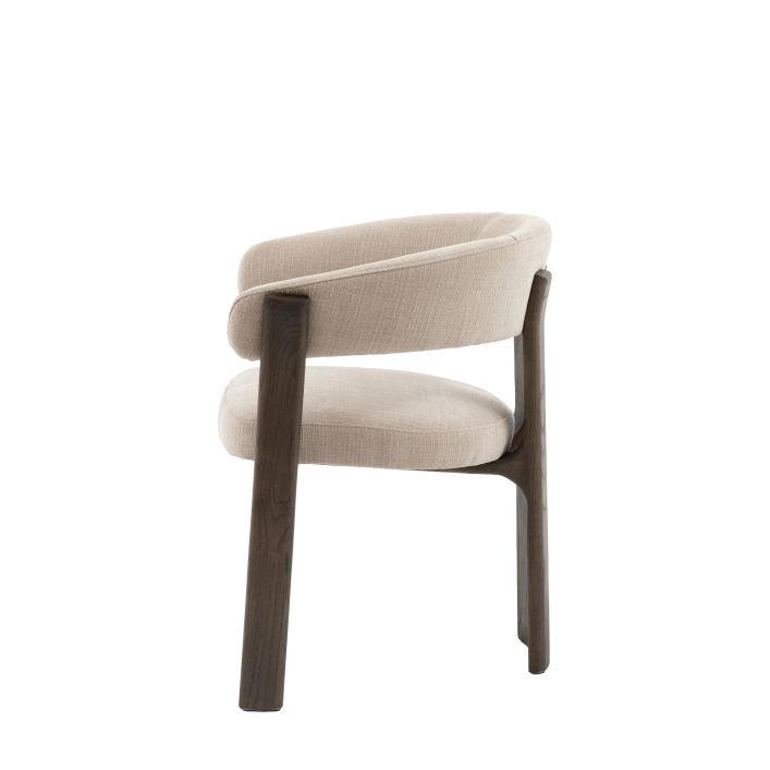 Gallery Direct Onda Dining Chair upholstered in a Natural coloured fabric with contrasting dark wooden legs
