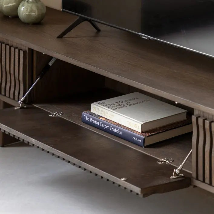 The Gallery Direct Onda Media Unit features 2 side drawers and a middle cabinet door with cable tidy access, and a slatted wave design to the cabinet doors